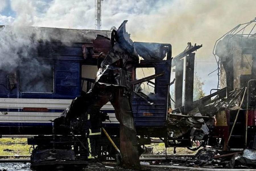 Smoke rises over a passenger train hit by today's Russian drone strike, amid Russia's attack on Ukraine, at the railway station in the town of Shostka, Sumy region, Ukraine October 4, 2025.