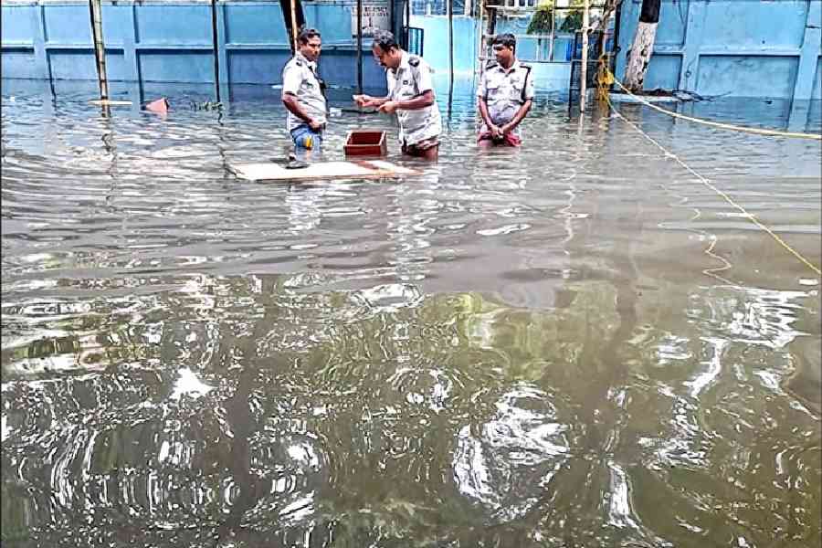 Guards on a flooded South Point High School campus in Ballygunge Place on September 24