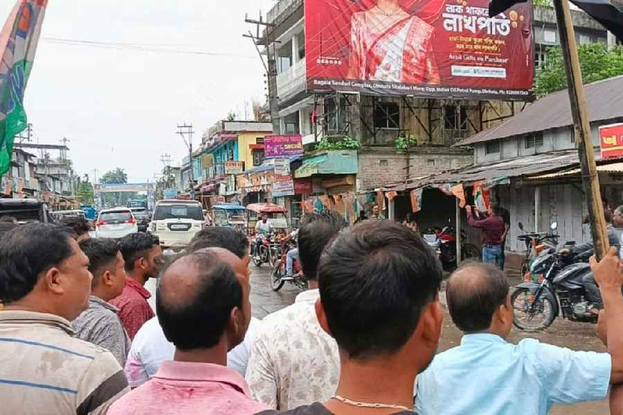 A Trinamool worker waves a black flag while the convoy of Nisith Pramanik passes through Bhetaguri in Cooch Behar district on Saturday.