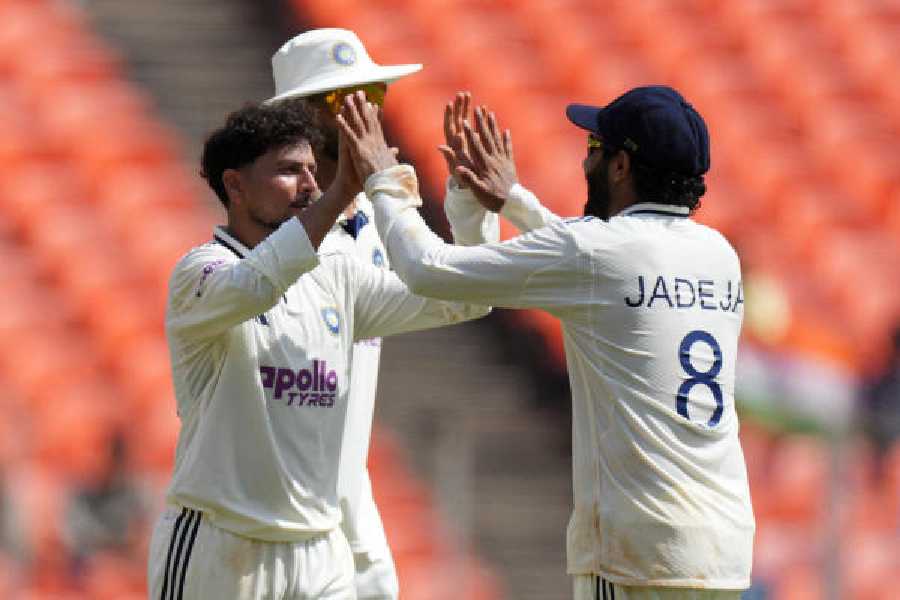 Kuldeep Yadav celebrates with Ravindra Jadeja (right)after dismissing West Indies’ captain Roston Chase in the first Test on Saturday.