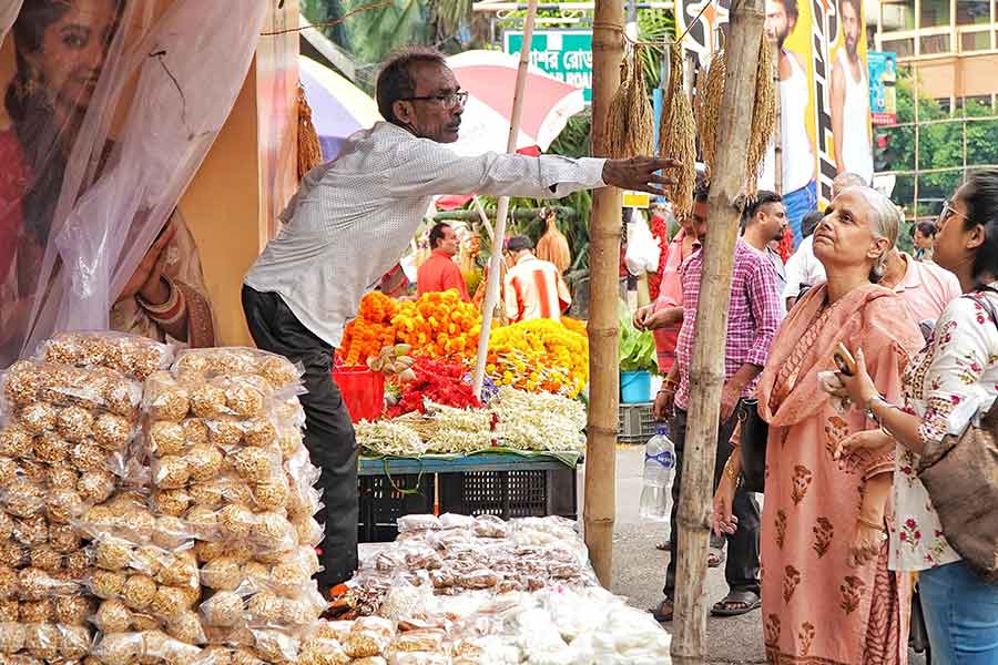 From narkel naru and tiler naru to kheer and narkel chapa sandesh — the street-side stalls fill the air with a sweet aroma