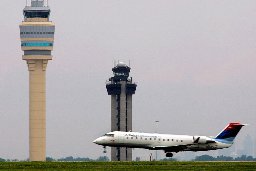FILE PHOTO: Delta Air Lines aircraft lands alongside new FAA air traffic control tower at Hartsfield-Jackson Atlanta International Airport.