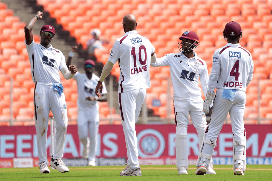 West Indies' captain Roston Chase celebrates wicket of India's captain Shubman Gill with teammates during the second day of the first Test cricket match between India and West Indies at the Narendra Modi Stadium in Ahmedabad, Gujarat, Friday, Oct. 3, 2025.