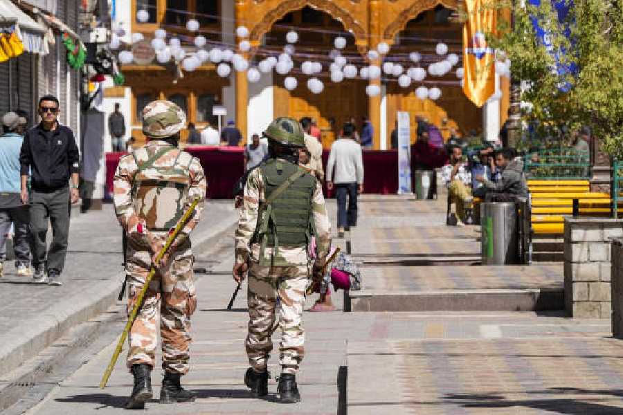Security personnel patrol a market in Leh on September 30. 