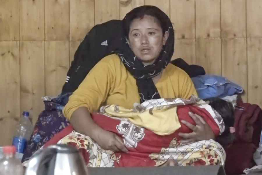 A disaster-affected woman with her child at a relief camp after last week's devastating landslides and floods, in Darjeeling district, West Bengal, Tuesday, Oct. 7, 2025.