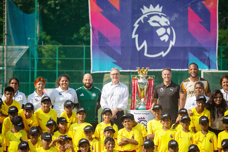 United Kingdom Prime Minister Keir Starmer and former footballer Michael Owen with children during a football showcase event organised by the English Premier League, in Mumbai, Maharashtra, Wednesday, Oct. 8, 2025.