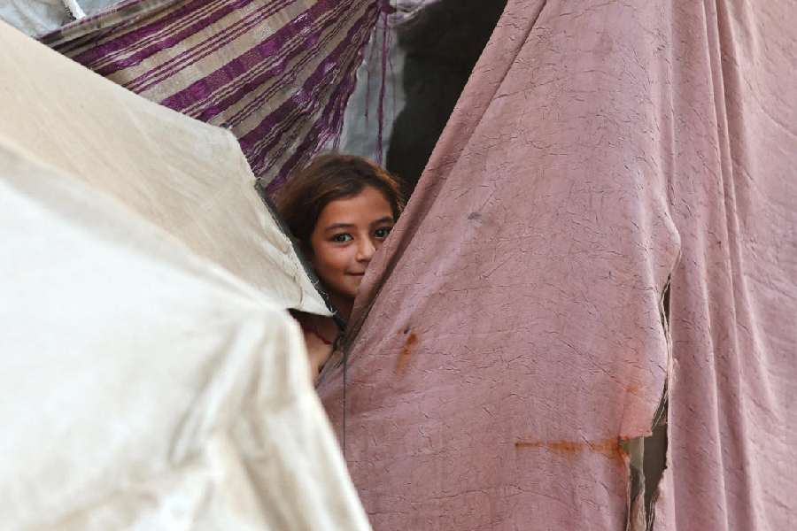 A Palestinian girl peeps through a tent at Khan Younis in the southern Gaza Strip on Thursday.