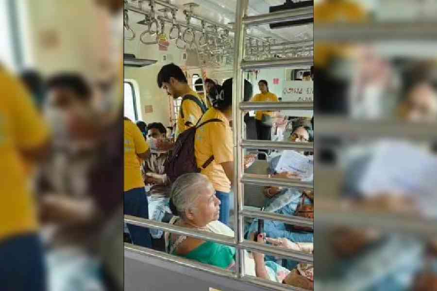 Mental health workers talk to commuters on a Krishnanagar-bound local train