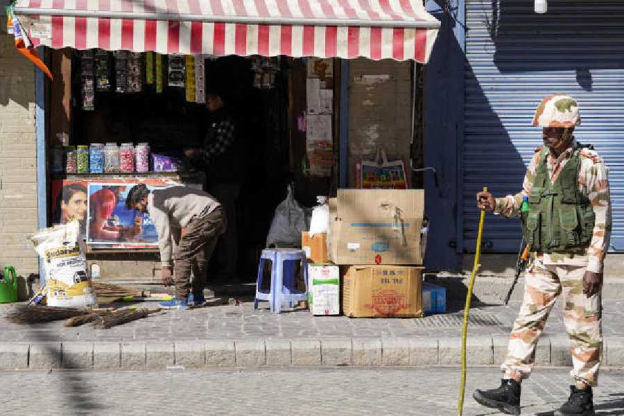 A security officer stands guard at a market in Leh.