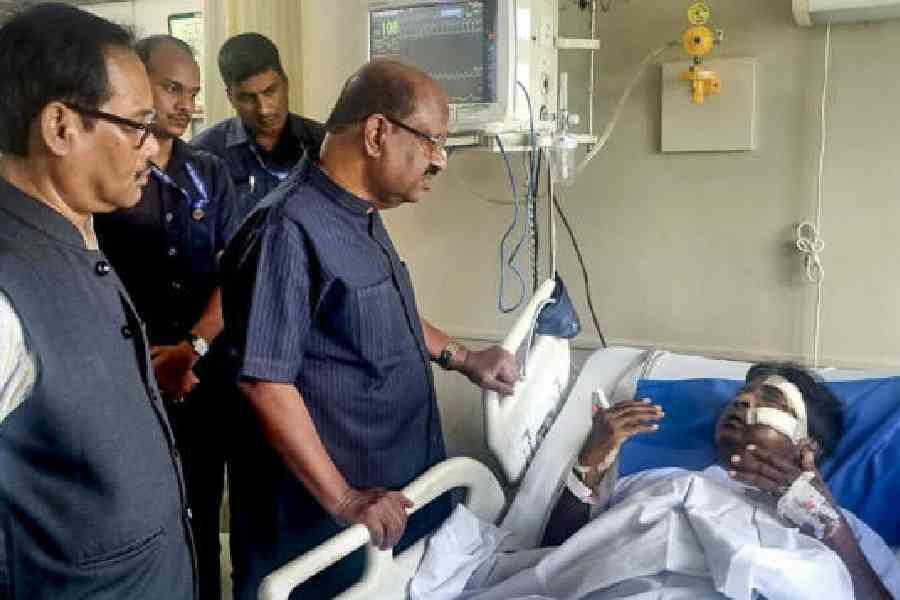 CV Ananda Bose meets injured MP Khagen Murmu at a hospital in Siliguri on Tuesday. (Raj Bhavan via PTI)