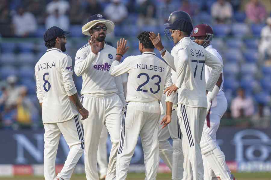 India's Kuldeep Yadav celebrates with teammates after taking the wicket of West Indies' Alick Athanaze during the second day of the second Test cricket match between India and West Indies, at the Arun Jaitley Stadium, in New Delhi