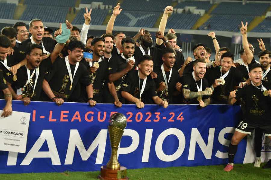Jubilant Mohammedan Sporting players, members of the support staff and officials with the I-League trophy at the Salt Lake Stadium on April 13, 2024. 