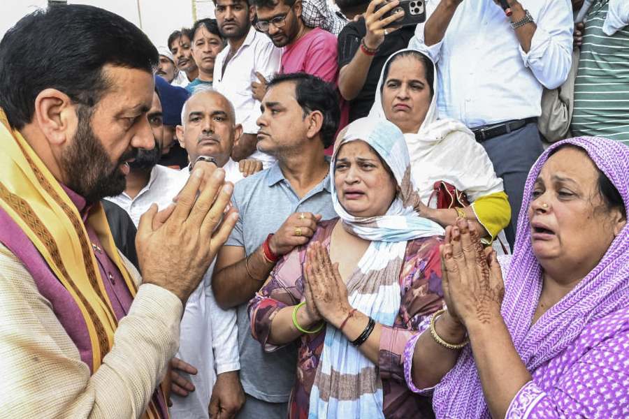 In this image posted on Oct. 15, 2025, Haryana Chief Minister Nayab Saini meets the family members of late ASI Sandeep Lather, in Rohtak.