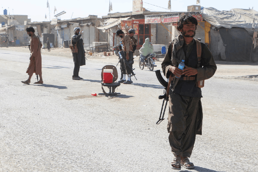Afghan Taliban fighters patrol near the Afghanistan-Pakistan border in Spin Boldak, Kandahar Province, following exchanges of fire between Pakistani and Afghan forces in Afghanistan.