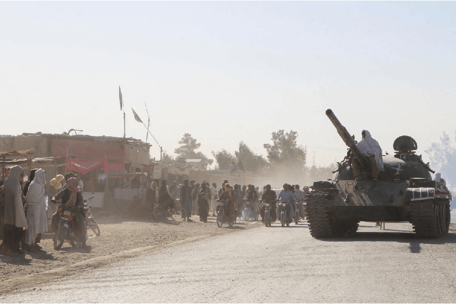 An Afghan Taliban fighter sits on a tank near the Afghanistan-Pakistan border in Spin Boldak, Kandahar Province, following exchanges of fire between Pakistani and Afghan forces in Afghanistan, October 15, 2025.