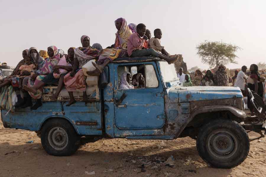 Newly arrived refugees from Darfur in Sudan, sit on a vehicle before being taken to a new camp on April 23, 2024 in Adre, Chad.