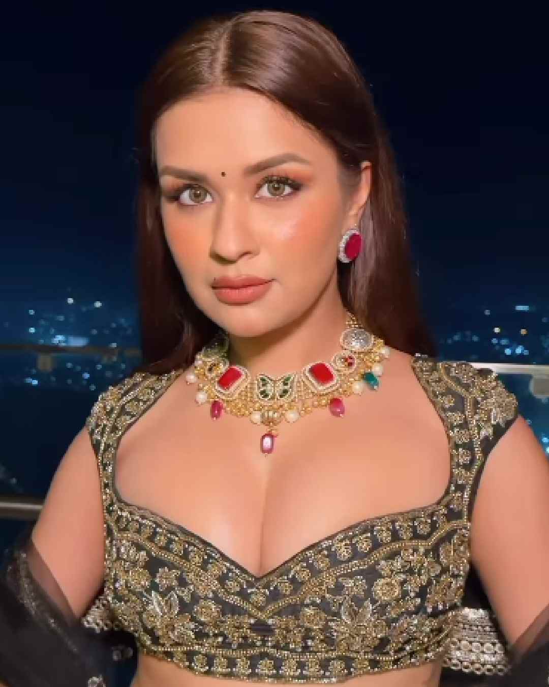Actress Avneet Kaur posed on the balcony of a skyscraper in a black embroidered lehenga.