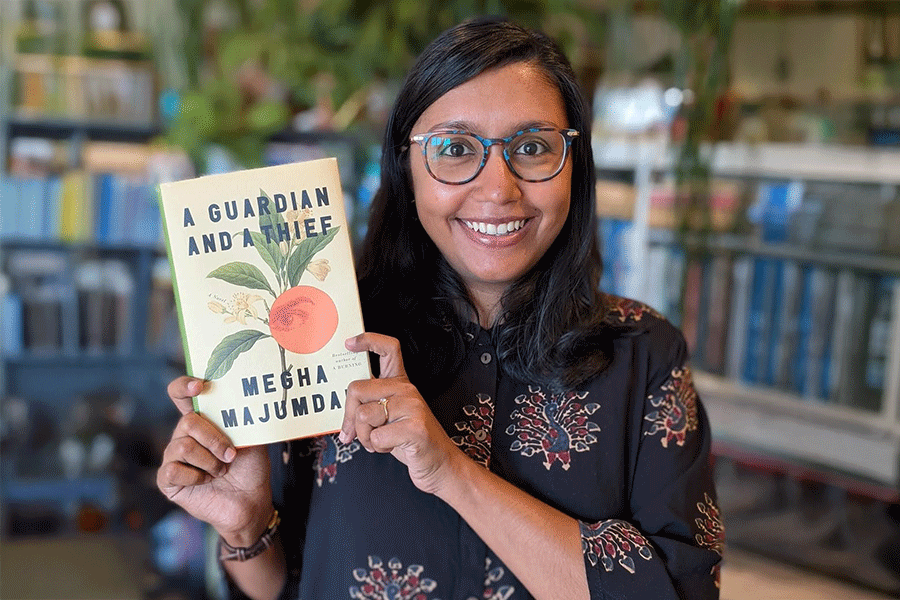 Megha Majumdar holding her book ‘The Guardian and a Thief’.
