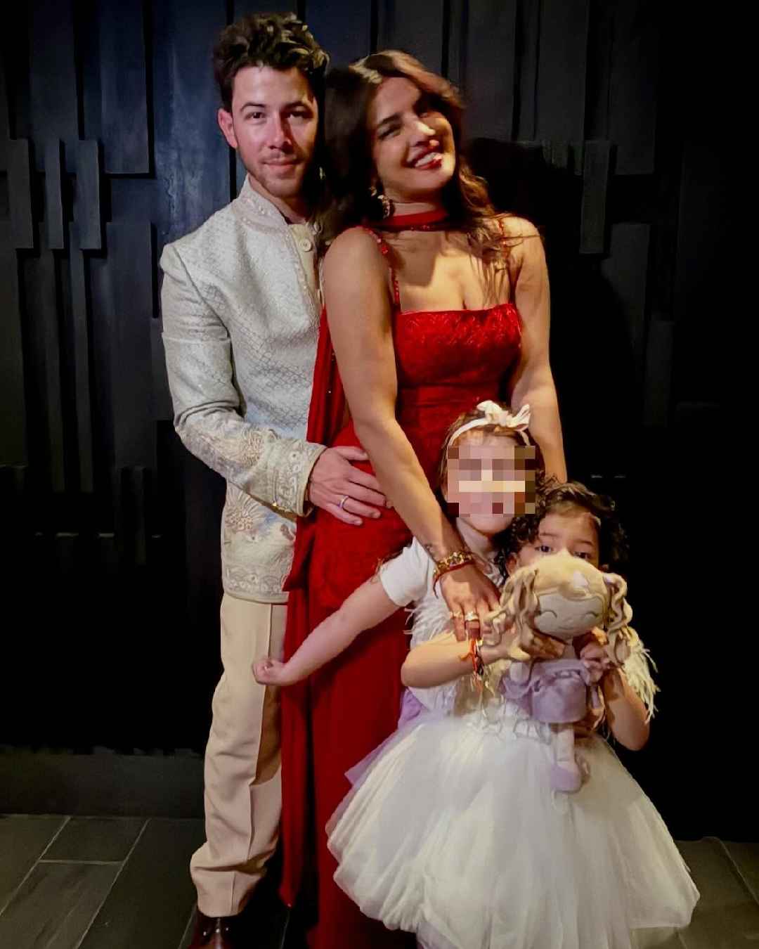 The couple posed with their three-year old daughter Malti and one of her friends.