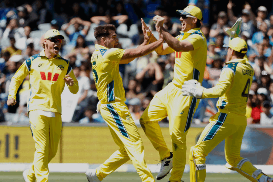 Australia's Xavier Bartlett, second left, is congratulated by teammates after taking the wicket of India's Virat Kohli during the one day international cricket match between Australia and India in Adelaide, Australia, Thursday, Oct. 23, 2025.