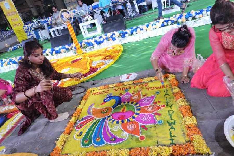 The team from NBCC Vibgyor Towers at work on their rangoli that came second.