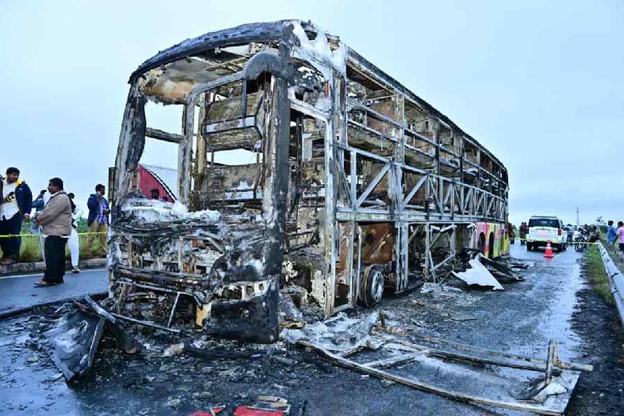 Charred remains of a Hyderabad-bound private bus that caught fire after a collision with a two-wheeler, near Chinnatekur in Kurnool district, Andhra Pradesh, Friday, Oct. 24, 2025.