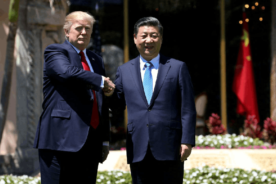 File photo: U.S. President Donald Trump (L) and China's President Xi Jinping shake hands while walking at Mar-a-Lago estate after a bilateral meeting in Palm Beach, Florida, U.S.