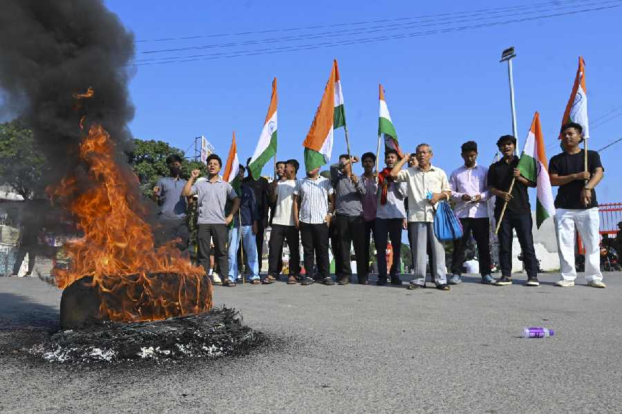 Smoke and flames billow from a tyre set on fire in Agartala during the bandh on Thursday.