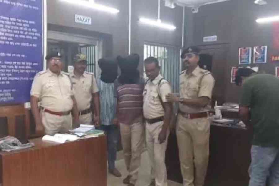 The two arrested bank employees in Murshidabad’s Farakka on Friday.  Pictures by Samim Aktar