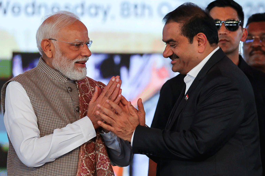 Prime Minister Narendra Modi greets businessman Gautam Adani, during the inauguration event of the Navi Mumbai International Airport in Ulwe, Raigad district.