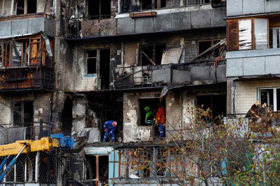 Rescuers work at the site of an apartment building damaged during an overnight Russian drone strike, amid Russia's attack on Ukraine, in Kyiv, Ukraine October 26, 2025.
