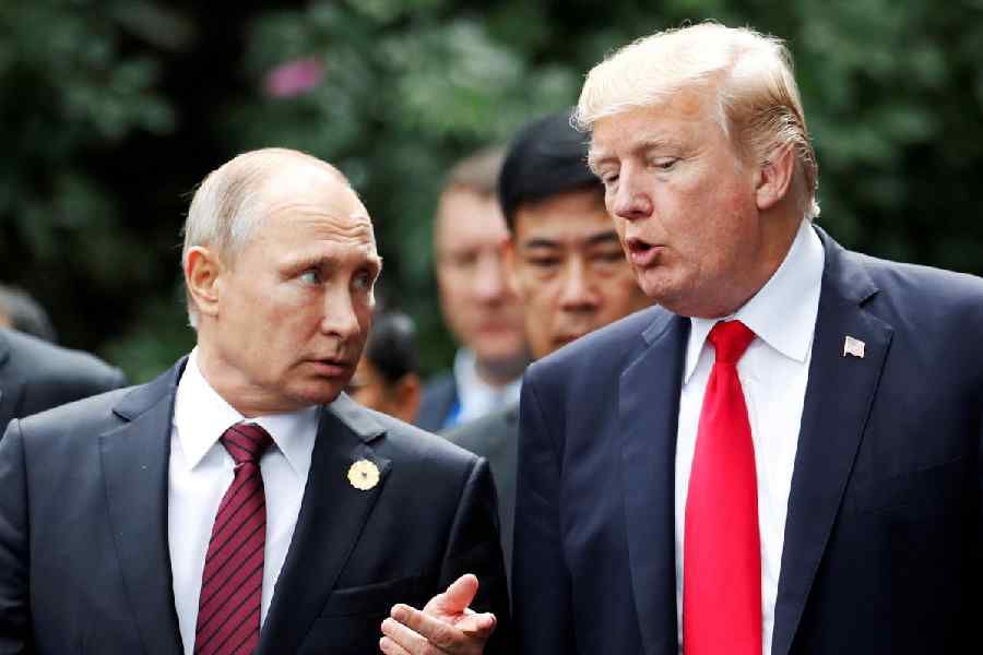 U.S. President Donald Trump and Russia's President Vladimir Putin talk during the family photo session at the APEC Summit in Danang, Vietnam November 11, 2017.