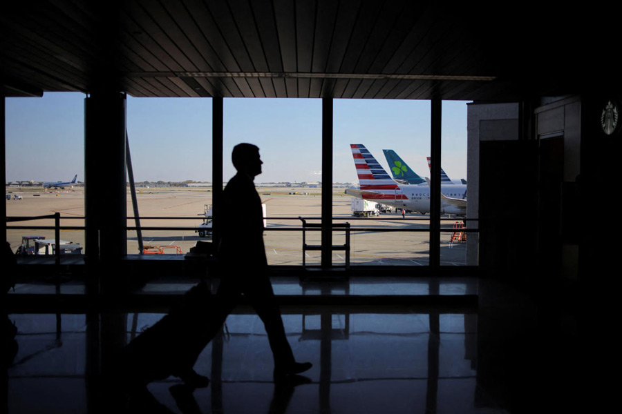 A traveller walks through Chicago O'Hare International Airport as the U.S. government shutdown continues, in Chicago, Illinois, U.S., October 26, 2025.