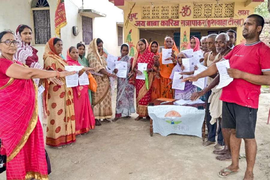Voters in Vaishali district show the enumeration forms given by a booth level officer (BLO) on July 4 this year during the special intensive revision of electoral rolls in Bihar.
