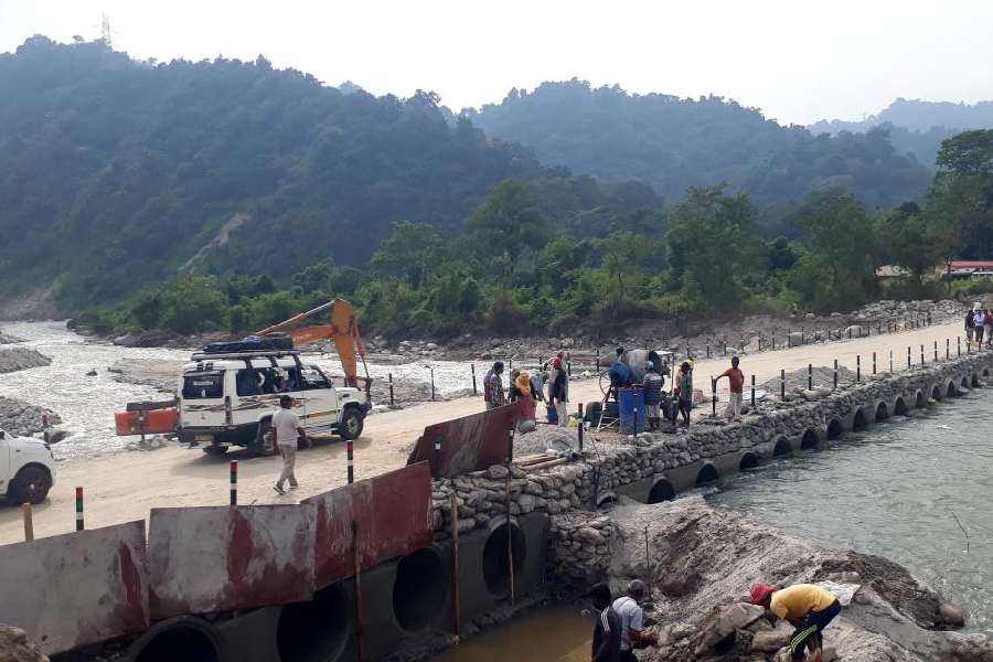 Traffic movement between Mirik to Siliguri starts after 22 days on the newly constructed link over the Balason river at Dudhia on Monday.