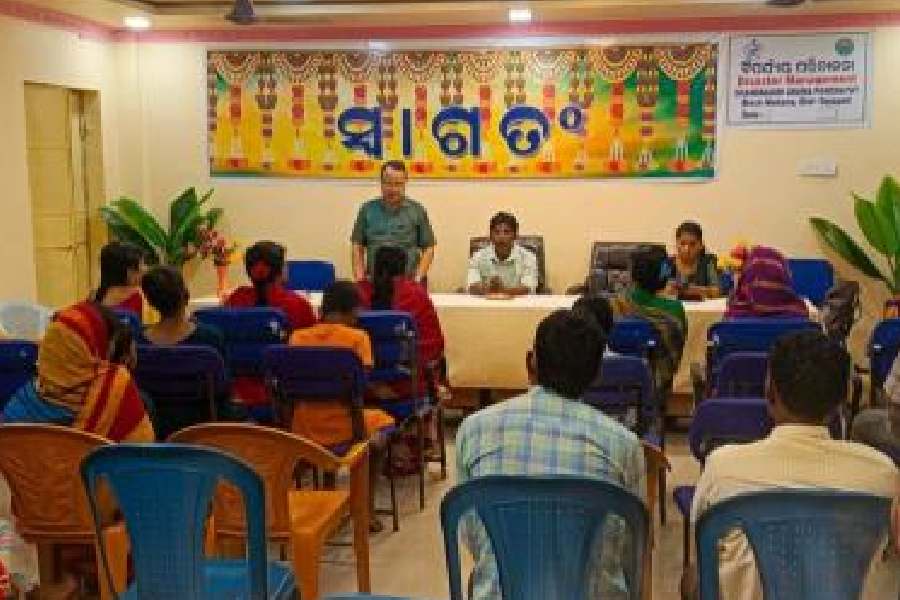 Officials urge residents to move to shelters in view of the cyclone at Chandragiri panchayat office in Gajapati district on Monday