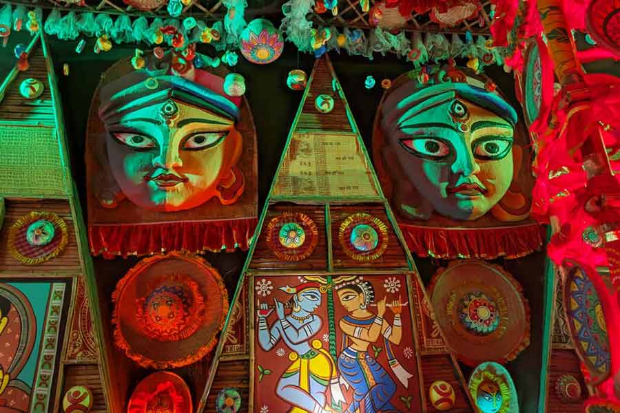 A pandal comes alive with traditional folk motifs and striking clay faces under a wash of festive lights as Chandernogore glows for Jagadhatri Puja