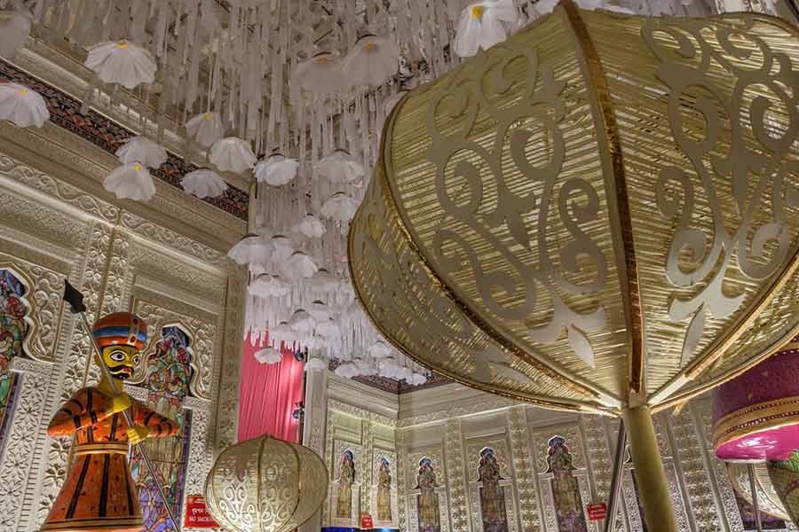Large ornamental installations and hanging lotuses add opulence to a pandal designed like a royal durbar
