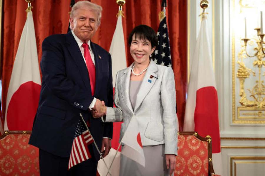 Donald Trump shakes hands with Sanae Takaichi at Akasaka Palace in Tokyo on Tuesday.