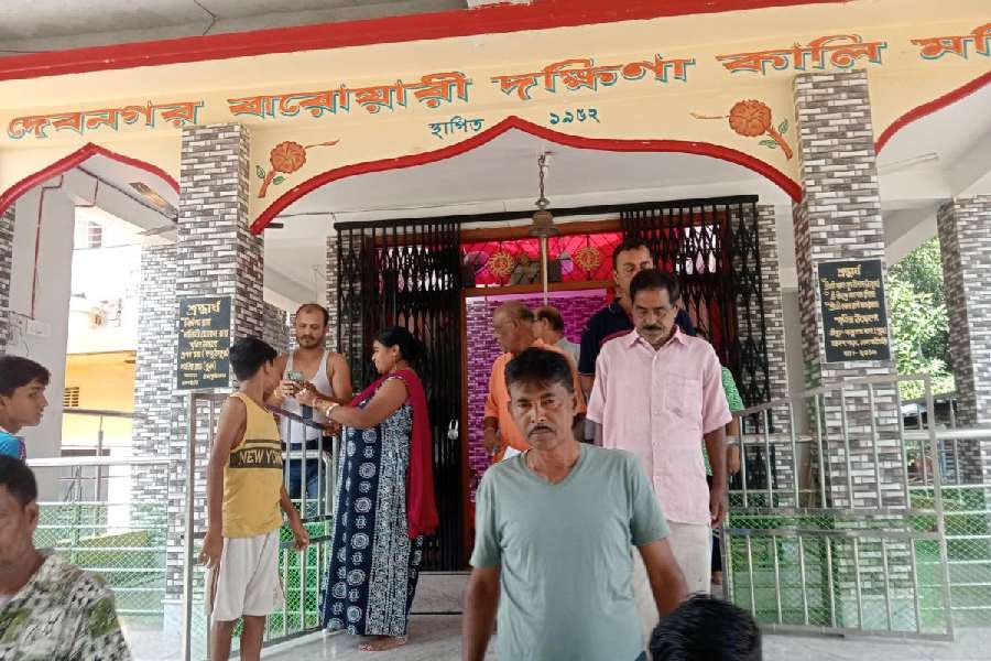 Locals at the Debnagar Barowari Dakshina Kali Temple in Debnagar on the outskirts of Jalpaiguri town on Tuesday after the loot.