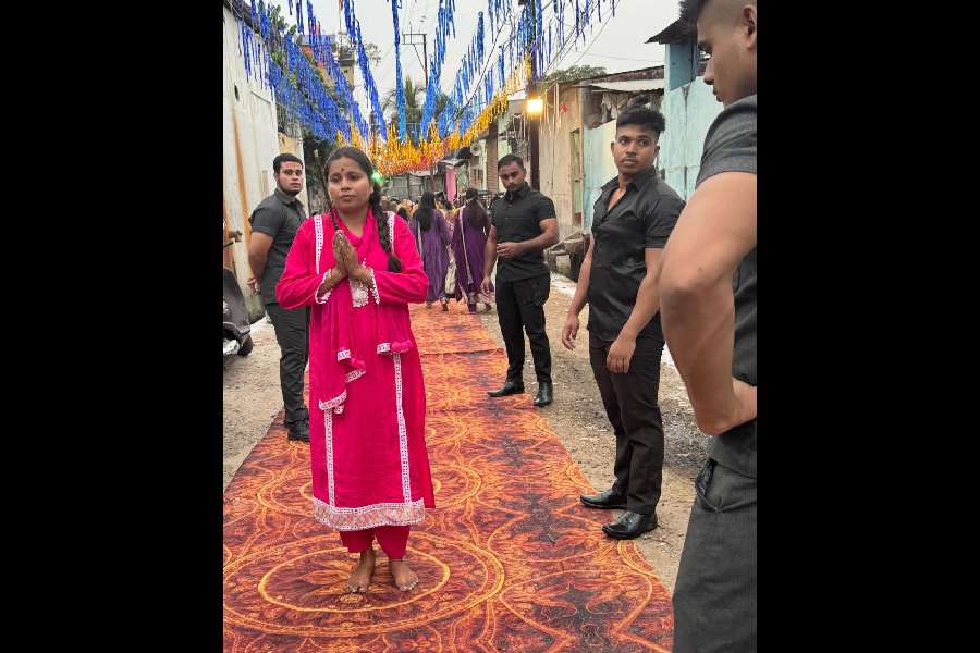 Anita Mahato, the BJP councillor of ward 5 of the Siliguri Municipal Corporation, being escorted by her private security guards during Chhath Puja on Tuesday morning