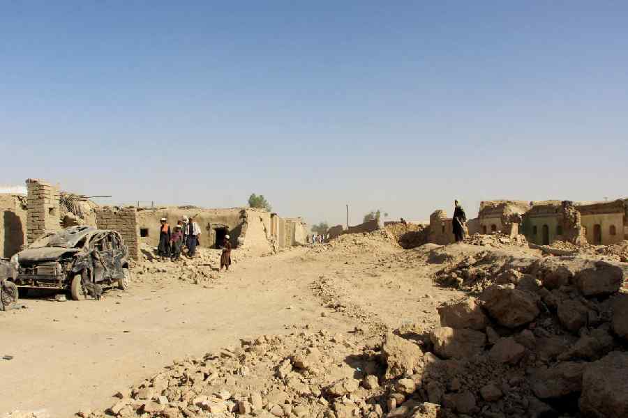 People inspect houses and vehicles destroyed during an airstrike, following a temporary ceasefire, amid the conflict between Afghanistan and Pakistan, in Spin Boldak district of Kandahar Province, Afghanistan, October 16, 2025.
