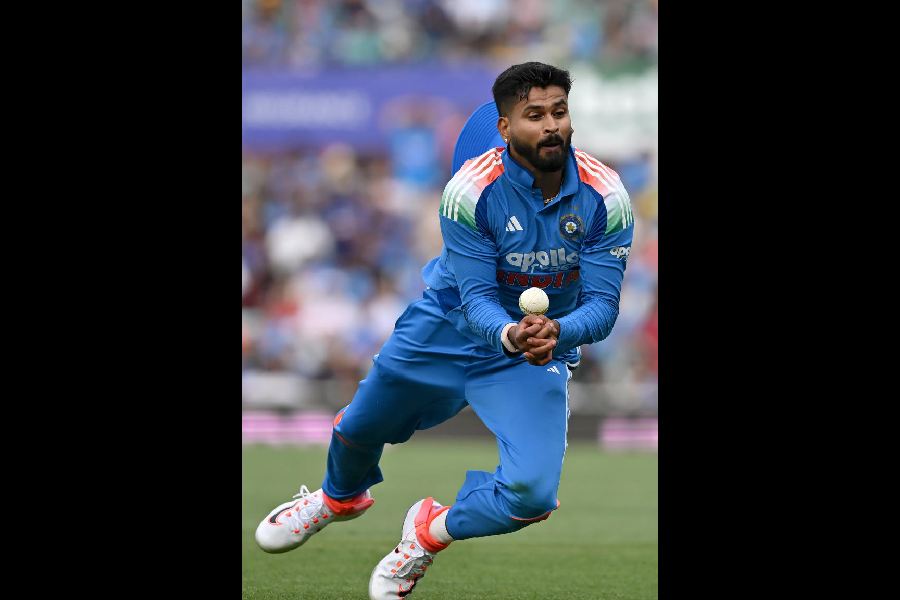 Shreyas Iyer falls while taking a catch to dismiss Alex Carey in the third ODI against Australia in Sydney on Saturday.