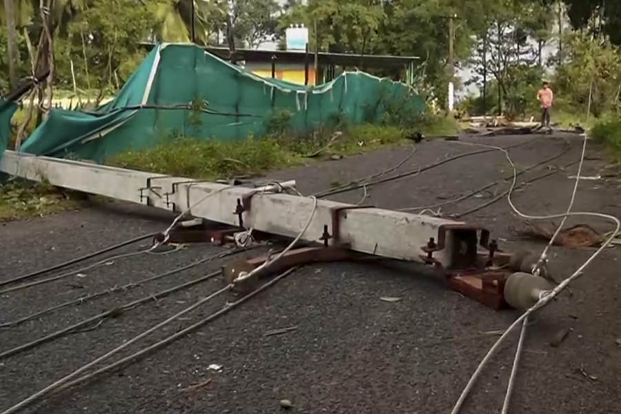 A broken electric pole lies across a road with wires scattered following the destruction caused by Cyclone Montha in Machilipatnam, Andhra Pradesh, Wednesday, Oct. 29, 2025.