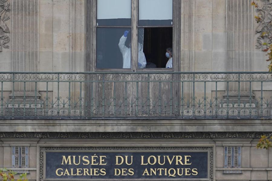 Police officers work inside the Louvre museum, Sunday, Oct. 19, 2025 in Paris.
