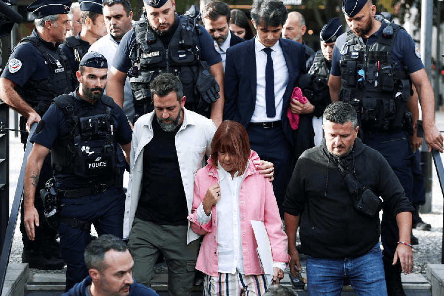 French woman Gisele Pelicot, the victim of a mass rape orchestrated by her then-husband Dominique Pelicot at their home in the southern French town of Mazan, leaves the court with her son Florian Pelicot, after the verdict, on the day of a courthouse hearing during the fourth and final day of the appeal trial filed by Husamettin D., one of the 51 people convicted in her rape trial, in Nimes, France, October 9, 2025.