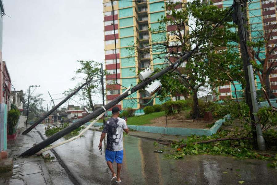 Fallen electrical posts on a street in Santiago, Cuba, on Wednesday. 