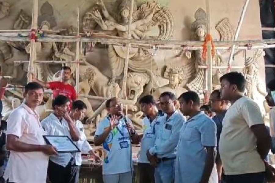 Members of the team interact with organisers of a puja in Midnapore.