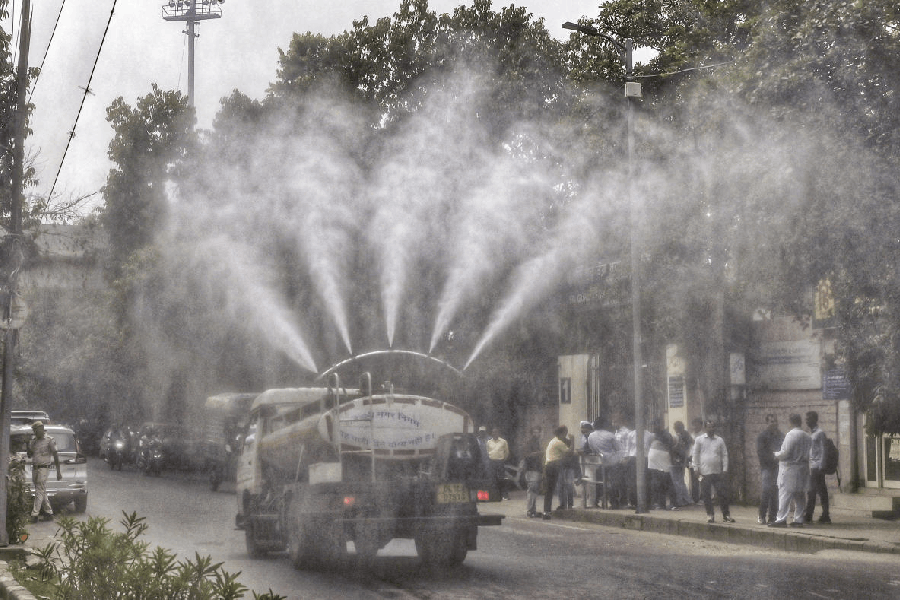 An anti-smog gun sprays water droplets to curb air pollution as air quality deteriorates across northern India, at North Campus, in New Delhi, Friday, Oct. 31, 2025.