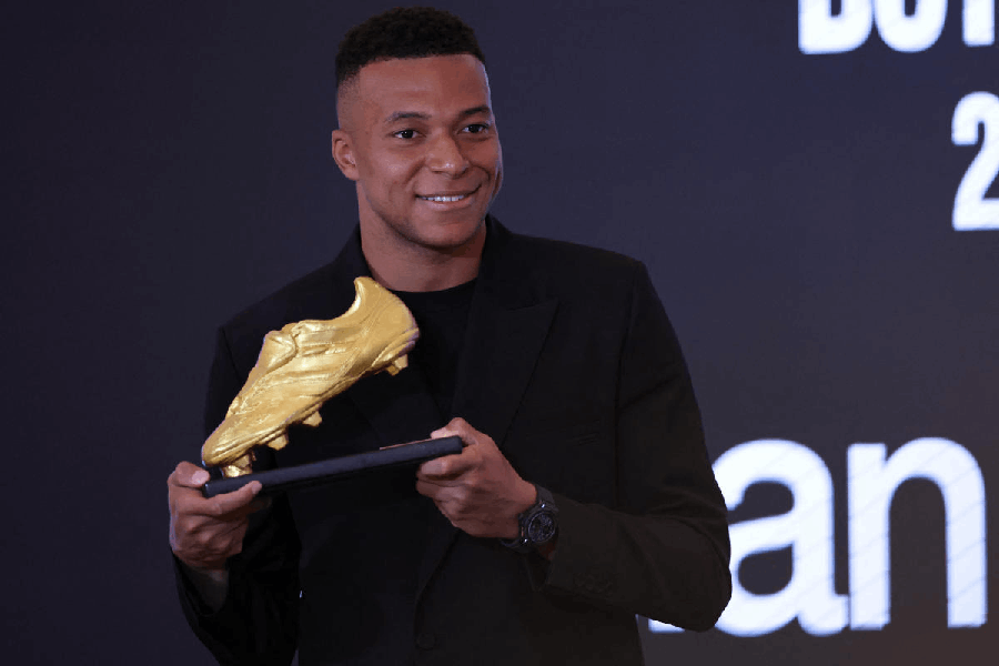 Real Madrid's Kylian Mbappe celebrates with European Golden Boot trophy.